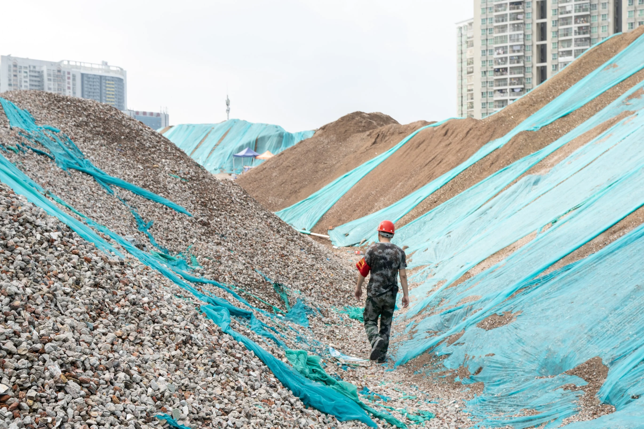 Back View Of A Laborer Walking Between Two Piles O 2025 01 08 09 21 19 Utc Min